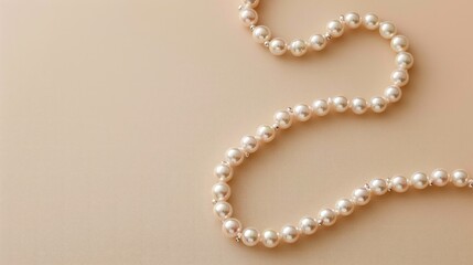 Obraz premium Pearl necklace displayed elegantly on beige background top down view Text space available