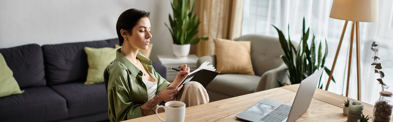 A woman sits in a comfortable home office, working on a project and taking notes in a notebook.