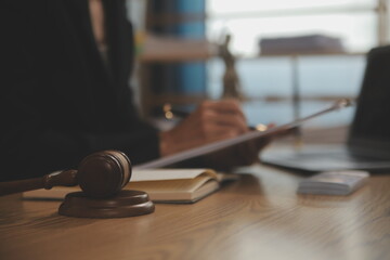 Judge gavel with Justice lawyers having team meeting at law firm background. Concepts of Law and...