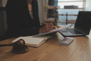 Judge gavel with Justice lawyers having team meeting at law firm background. Concepts of Law and...