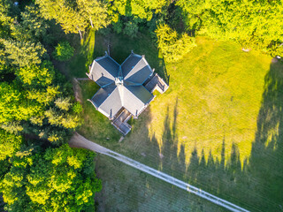 A unique Schwarzenberg Vault in Orlik nad Vltavou, Czechia, surrounded by lush greenery and a gravel path, nestled within the forested landscape.