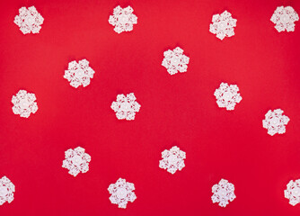 Red background with white snowflake. The atmosphere of Christmas and New Year. Christmas banner, mock-up, Pattern