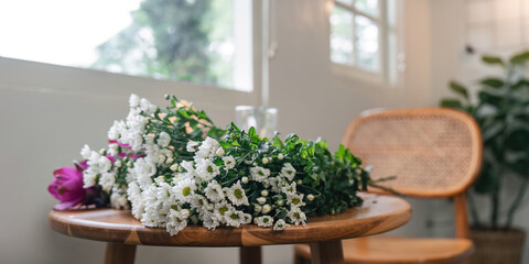 Beautiful Flower Arrangement on Wooden Table in Cozy Home Interior with Natural Light and Rattan Chair