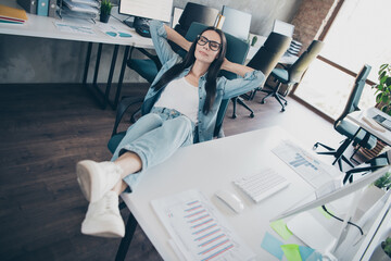 Photo of attractive good mood lady recruiter dressed denim jacket smiling relaxing arms behind head...