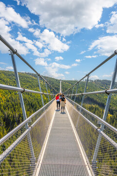 The Sky Bridge 721 is the worlds longest suspension footbridge in Dolni Morava Resort, Czechia. Visitors enjoy scenic forest views as they walk.