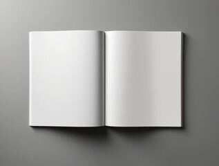 Blank open magazine mockup. The magazine is laid flat on a smooth, grey surface, making it an ideal template for showcasing design layouts, advertisements, articles, or any other print media content. 