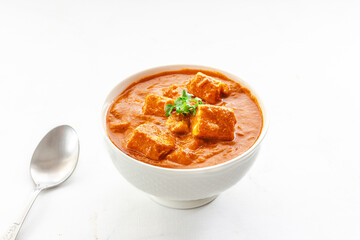 Paneer Butter Masala, Indian Cottage Cheese Curry with Butter and Cream Garnished with Cilantro
