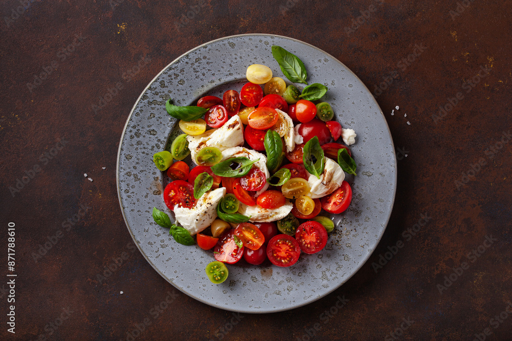 Wall mural healthy colorful tomato mozzarella basil salad with balsamic vinegar dressing