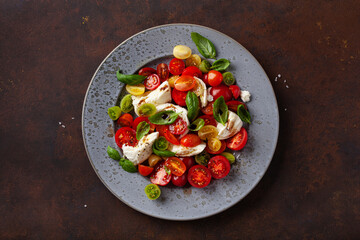 healthy colorful tomato mozzarella basil salad with balsamic vinegar dressing