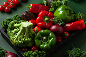 assorted red and green vegetables tomatoes, bell peppers, kale avocado