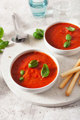 tomato and bell pepper vegetarian soup on green background