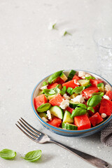 watermelon salad with feta cheese, cucumber and basil. healthy summer dessert
