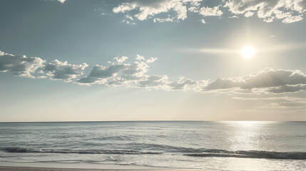 Fototapeta premium Serene seashore with calm ocean and cloudy sky
