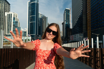 teenagers in the city, girl in a red dress, blonde, teenager with glasses, tall buildings