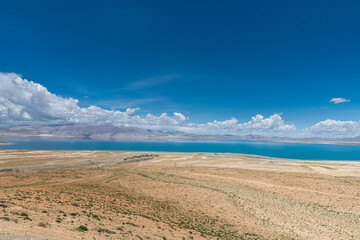 Fototapeta premium The sacred Manasarovar lake with blue transparent water in the mountains of Tibet