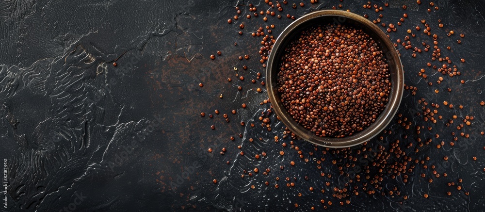 Aufkleber Red quinoa superfood displayed from a top view on a black background with ample copy space image available.