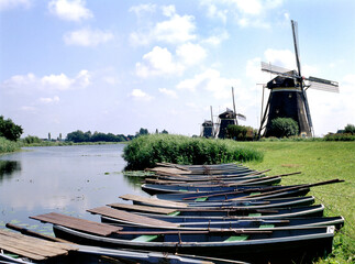 Rowing boats in the ditch with windmills © robepco