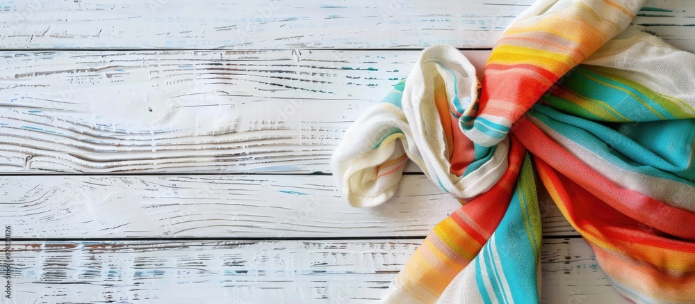 Poster a colorful fabric napkin lies on a white wooden surface, creating a lovely backdrop for any 'copy sp