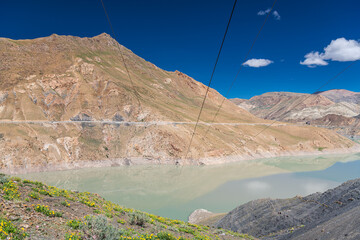 The turquoise colored Manla reservoir on the Nyang river seen from the 4200 ms.high Smira...