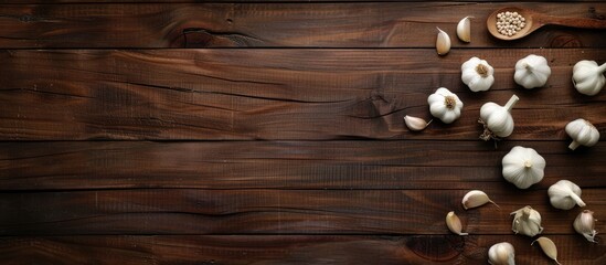 Dark wooden background with garlic, offering ample copy space image.