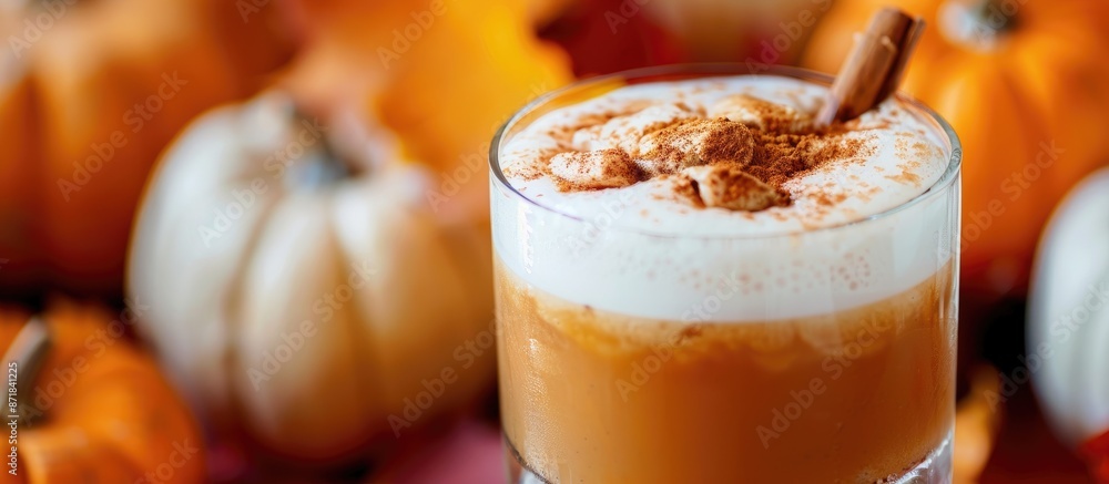 Poster close-up of a pumpkin spiced drink with foam and cinnamon garnish against a backdrop of pumpkins, pe