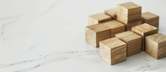 Create the perfect brand logo on wooden cubes atop a chic white table background, providing an ideal copy space image for branding purposes.