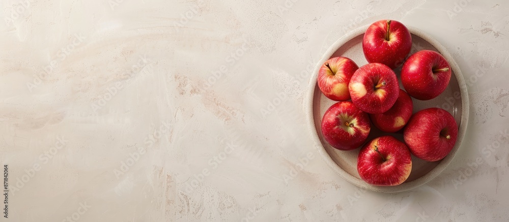 Poster an aerial perspective of apples arranged on a dish against a light cream backdrop, showcasing ample 