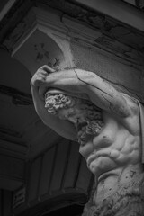 statue of Atlas holding up a balcony in Radom, Poland