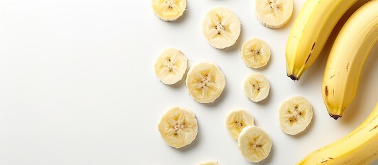 Obraz premium Banana slices on a white background with copy space image.