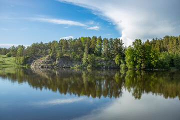 A beautiful lake with a forest in the background