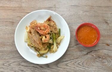 fried glass noodles chicken and pork meat couple crispy pickled squid and shrimp with vegetable on plate dipping sukiyaki sauce