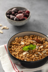Crispy homemade granola with sliced almonds in a bowl. Healthy food