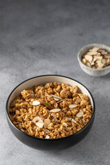 Crispy homemade granola with sliced almonds in a bowl. Healthy food