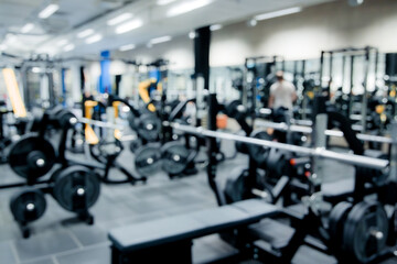 Fototapeta premium Blurred image of gym interior and fitness equipment. Modern background concept.