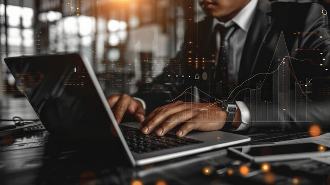 Businessman Working On Laptop With Financial Data Overlay