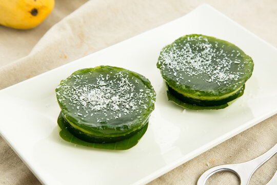 Chinese colorful green cake served in dish isolated on table side view hong kong baked food dessert