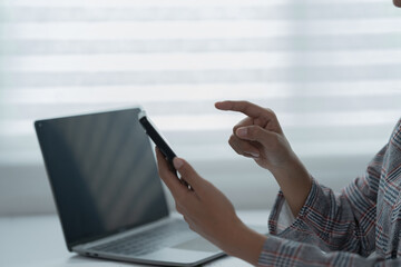A photograph of a woman's hand using a pen and calculator to work.