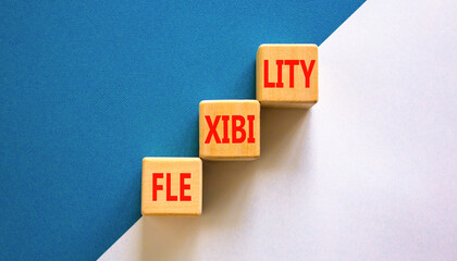 Obraz premium Flexibility symbol. Concept word Flexibility on beautiful wooden blocks. Beautiful white and blue background. Business flexibility concept. Copy space.