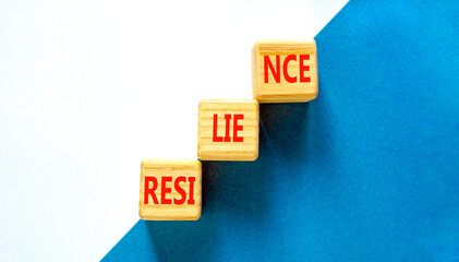 Resilience symbol. Concept word Resilience on beautiful wooden blocks. Beautiful blue and white background. Business resilience concept. Copy space.