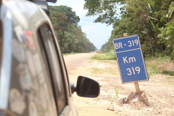 carro comum na BR-319, no Amazonas, em período de seca, quando há muita poeira no trecho sem...