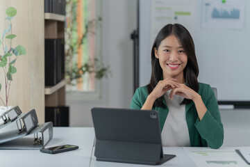 mage of a young Asian businesswoman holding a credit card.