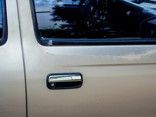 Rust and paint damage on part of the old car body. Peeling off old paint on the car body