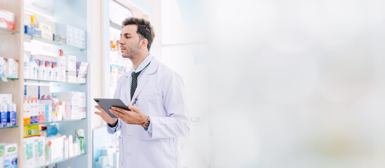 Pharmacist working in Pharmacy health service in drugstore, professional doctor in medicine shop healthcare wide space banner for advertising.