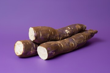 Fresh organic cassava root on purple background