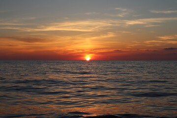 Sunset over the sea on a cloudy summer evening