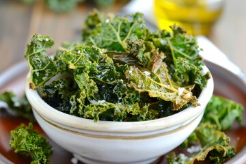 Healthy snack of homemade kale chips baked in oven with olive oil and sea salt