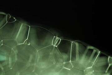 Green liquid, bubble in macro, movement of liquid in a bubble, abstract background, copy space,...