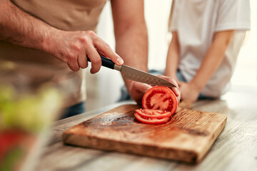 Happy Family Engaged in Preparing a Healthy Salad Together in Their Home Kitchen