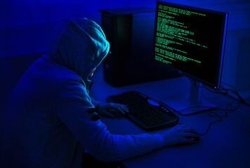 Cybercrime and Hacking Concept. Unrecognizable Hacker Using Computer Virus Program For Cyber Attack