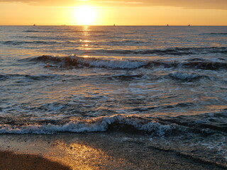 Sunset - View of a romantic sunset over the sea. The play of light from the setting sun creates a...